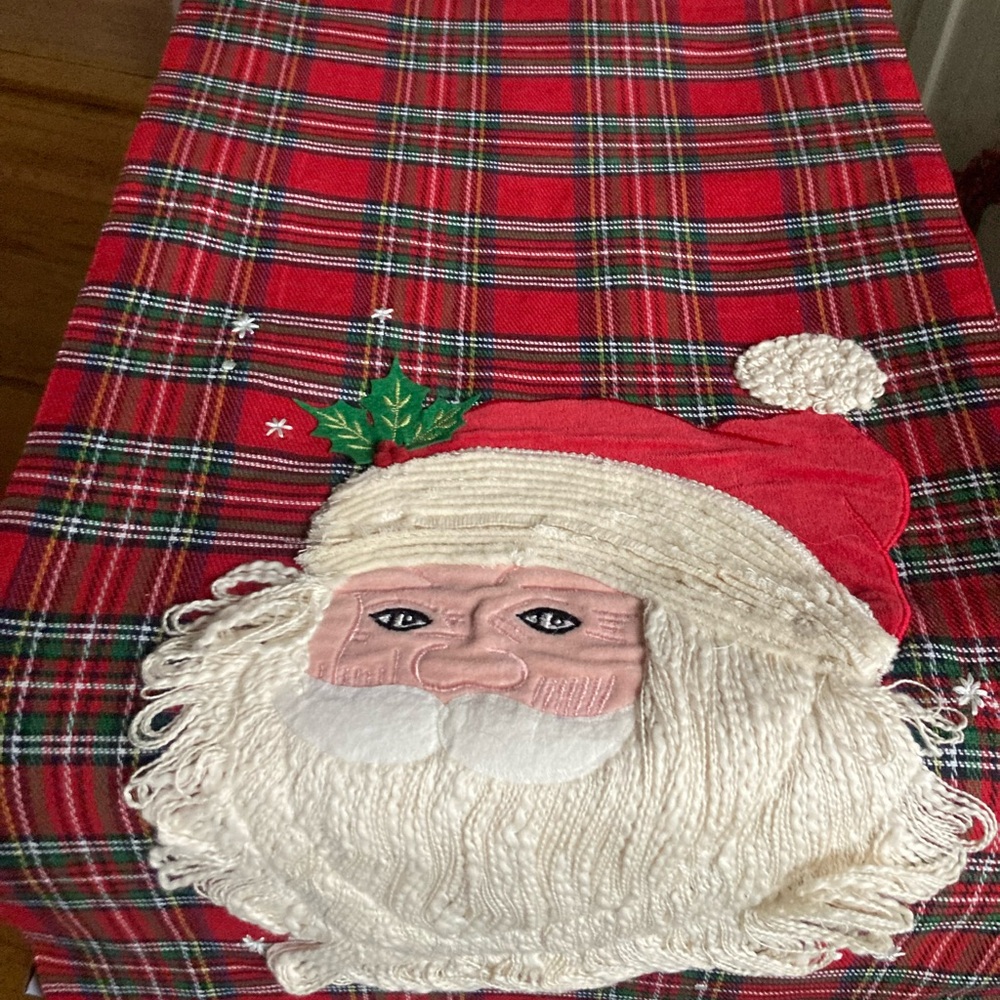 Brand new Christmas table runner, plaid with Santa, red on the other side.
